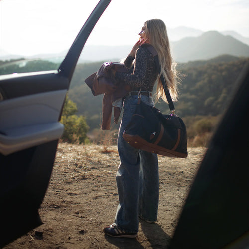 ELLE Luxe Journey 30L Twill and Vegan Leather Weekender Duffel Bag in black demonstrating practical use