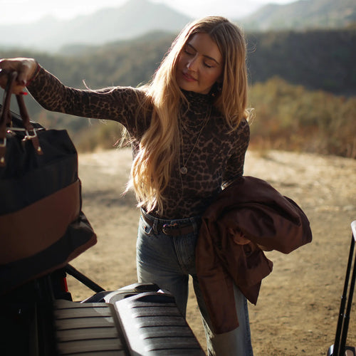 ELLE Luxe Journey 30L Twill and Vegan Leather Weekender Duffel Bag in black demonstrating practical use