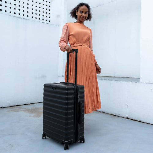 ELLE Excursion Expandable Chick 3-Piece Luggage Set in Black demonstrating practical use