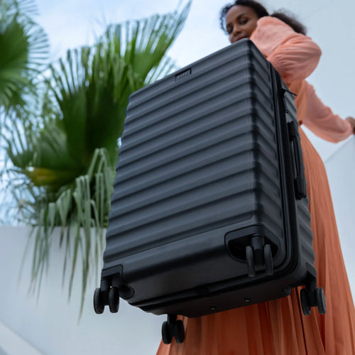 ELLE Excursion Expandable Chick 3-Piece Luggage Set in Black demonstrating practical use