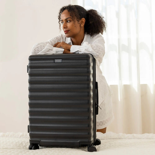 ELLE Excursion Expandable Chick 3-Piece Luggage Set in Black demonstrating practical use