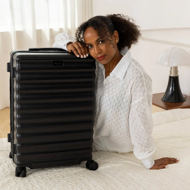 ELLE Excursion Expandable Chick 3-Piece Luggage Set in Black demonstrating practical use