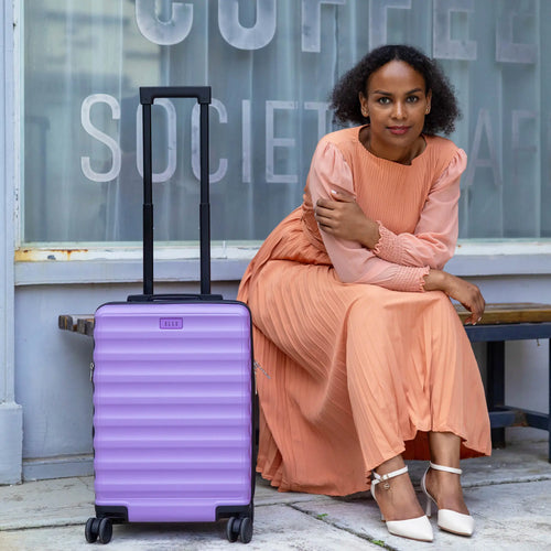 ELLE Excursion Expandable Chick 3-Piece Luggage Set in Black demonstrating practical use