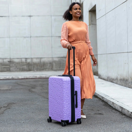 ELLE Wayfarer Expandable Sleek Monogram 3-Piece Luggage Set in Navy demonstrating practical use