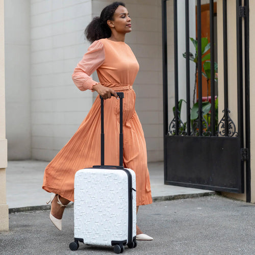 ELLE Wayfarer Expandable Sleek Monogram 3-Piece Luggage Set in Navy demonstrating practical use