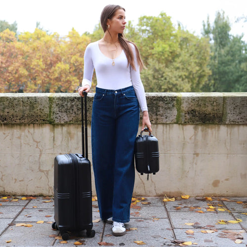 ELLE Expedition 3 Piece Expandable Polycarbonate Spinner Luggage Set in black demonstrating practical use