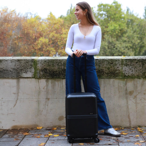 ELLE Expedition 3 Piece Expandable Polycarbonate Spinner Luggage Set in black demonstrating practical use