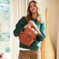 ELLE Compass 10L Vegan Leather Monogram Mini Backpack in brown demonstrating practical use